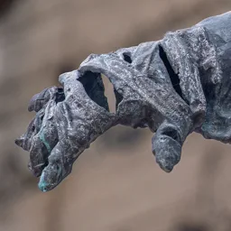 Close-up of the memorial figure's hand.