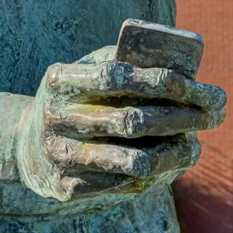 Close-up of Steve Jobs's hand holding the first iPhone.