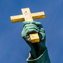 Close-up of Saint Gerard's hand holding a cross.