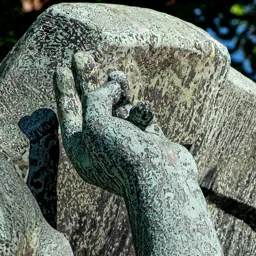 Close-up of the Rushing Angel's left hand.