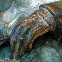 Close-up of Zoltán Kodály's hand holding wildflowers.