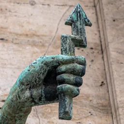 Close-up of the raised hand holding a lightning bolt.