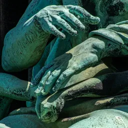 Close-up of four hands above a handshake between two children.