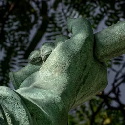 Close-up of the soldier's right hand holding a grenade.