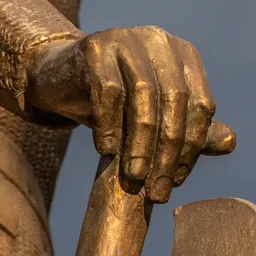 Close-up of Saint Ladislaus's left hand resting on the battle axe.